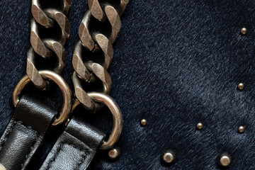 Dark fur with metal decorations, background and texture of black women's bag