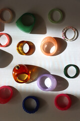 Collection of colorful plastic rings on white background. Top view.