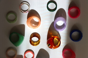 Collection of colorful plastic rings on white background. Top view.