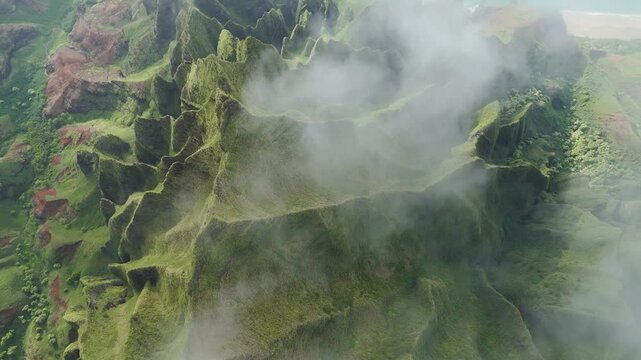 Aerial view of Na Pali Coast with cliffs and clouds, United States.