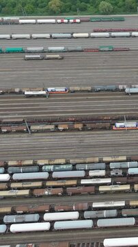 Railway infrastructure aerial view revealing dense network of parallel tracks with multiple freight cars, displaying logistical complexity and industrial transportation scale