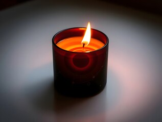 Lit Candle in Dark Glass Jar: Ambiance, Relaxation, and Warmth