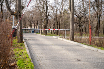 Automatic barrier, security system at the entrance to the city green park area.