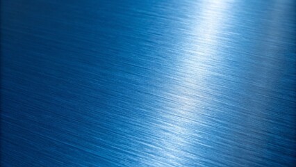 A closeup of a blue brushed metal surface with a bright, reflective sheen