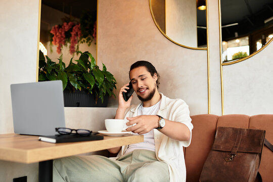 Remote working young man enjoys coffee in a vibrant cafe on a sunny day