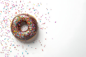 Chocolate donut topped with colorful sprinkles on a white background, ideal for dessert promotion