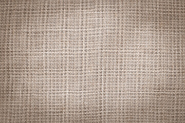 Hessian sackcloth woven jute burlap hemp fabric cloth textile texture pattern background in sepia...