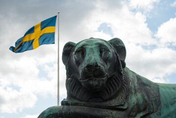 Bronze lion statue with Swedish flag in Stockholm