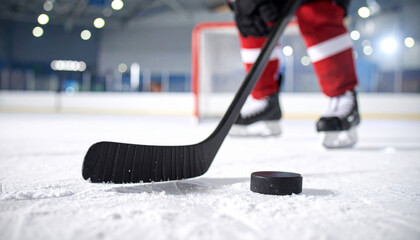 Fototapeta premium ice hockey stick and puck on focus in ice stadium 