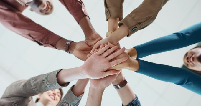 Low angle, hand stack and business people in office for teamwork, collaboration and support. Community, startup company and workers in circle for solidarity, cooperation and partnership synergy