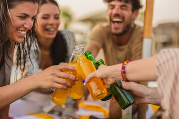 Friends toasting drinks at beach party