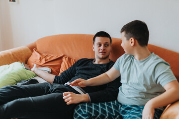 A warm scene depicting two people sharing a moment of dialogue on a sofa, conveying connection and...