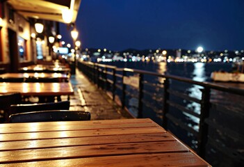 Portrait of an empty table in a harborside cafe after rain at night