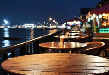 Portrait of an empty table in a harborside cafe after rain at night