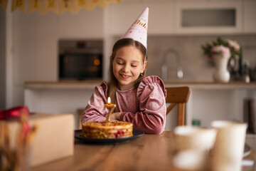 Girl Celebrating Her Birthday with a Candlelit Cake at Home