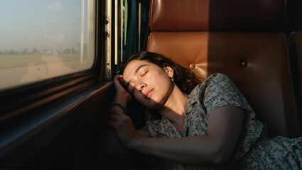 Woman sleeping near window on train