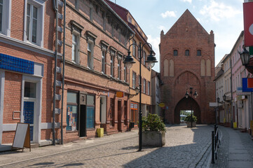 Stone gate from 14th century that blends into modern city. 1 Maya Street. Świdwin, Poland.
