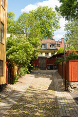 Quiet Stockholm street with old building and green trees