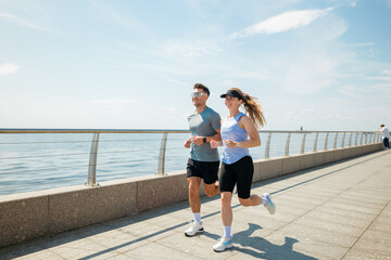 Jogging along the waterfront promenade on a sunny afternoon with friends © muse studio