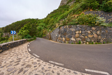 Curved mountain road and trail stairs