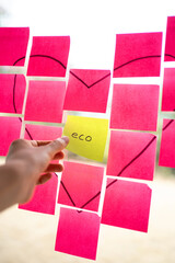 Manager choosing eco-friendly solution among many options on sticky notes