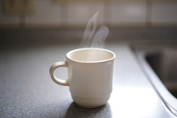 Obraz premium Steaming Coffee Cup Morning Kitchen Countertop Still Life