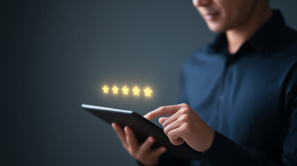 A person taps a tablet displaying five glowing stars, indicating a top customer rating or excellent online review, against a dark background.