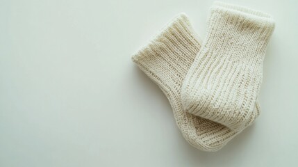 Cozy cream-colored knitted socks on a minimalist surface