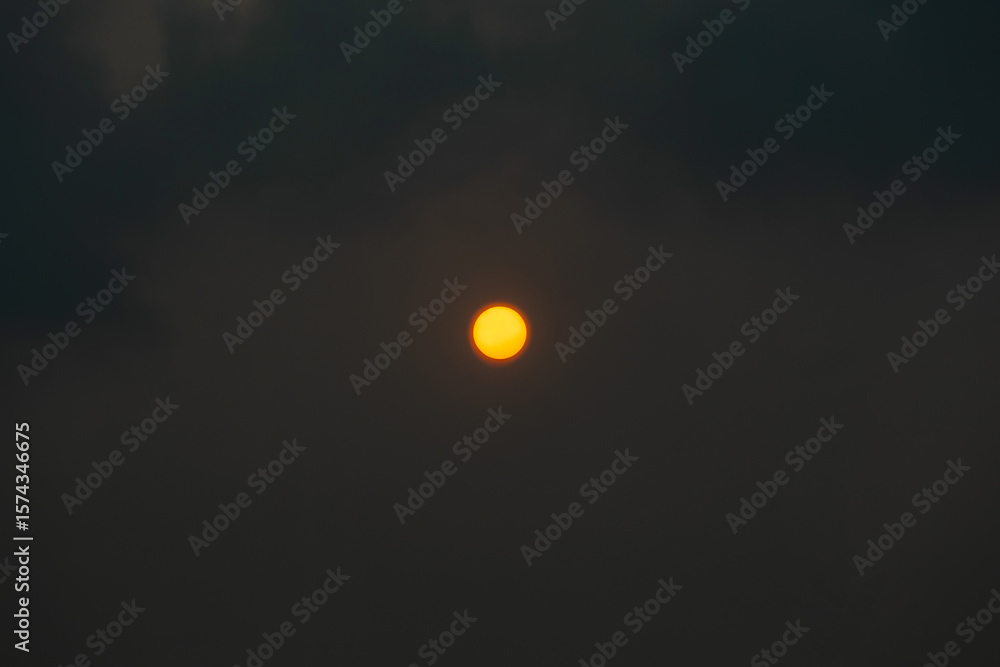 Canvas Prints red orange sun through the hazy clouds.