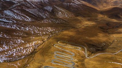 Aerial view of the winding road leading to Mount Everest from the Tibetan side, surrounded by...