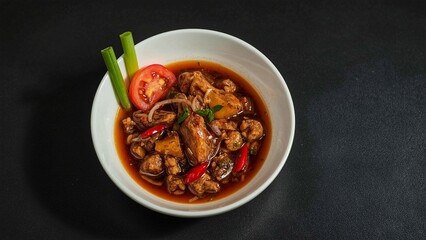 Anchovy Sambal with Tomato and Celery Garnish on Matte Black Table 