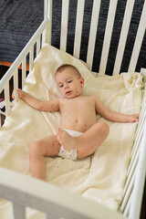 Toddler with Chickenpox Sitting in Bed