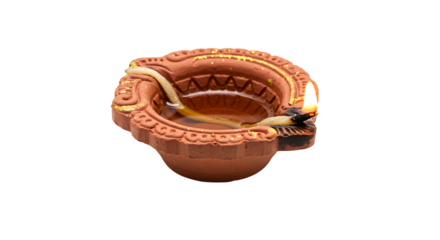 Earthen diya lamp filled with liquid  wick burning on a black background