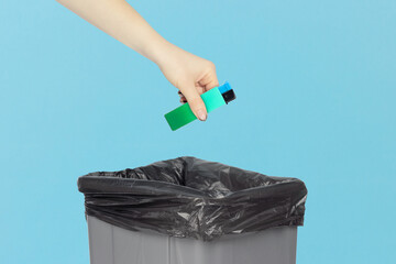 throw the lighter in the trash, outstretched hand with a lighter in front of the trash can, the concept of the dangers of smoking cigarettes, quitting smoking
