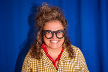 Confident female designer in glasses and bandana smiling, embodying creative spirit against bright...