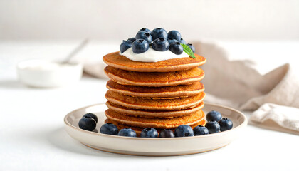 Delicious gluten-free buckwheat pancakes served on ceramic plate with blueberries
