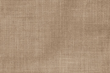 Hessian sackcloth woven jute burlap hemp fabric cloth textile texture pattern background in sepia...