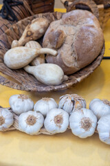 Rustic still life of garlic, pumpkins, and rye bread on a wooden tray