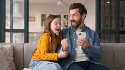 Positive joyful happy Caucasian family dad parent guy father celebrating man daughter win male...