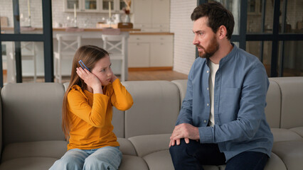 Furious Caucasian man father male screaming at sad afraid child girl punishing for bad behavior...
