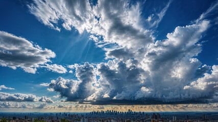 "Sunbeams breaking through dramatic clouds over a city skyline"