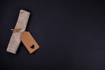 Rustic kraft paper tag with heart cutout on black background