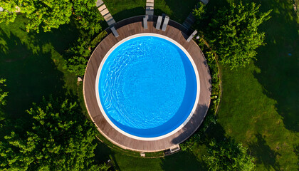 Aerial view circular pool with green garden.