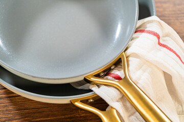 Overlapping Ceramic Pans with Red-Striped Towel