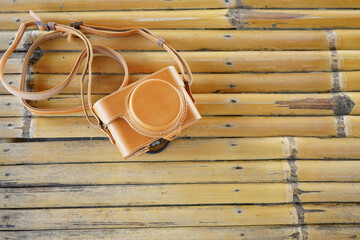 Leather camera case on top  bamboo background