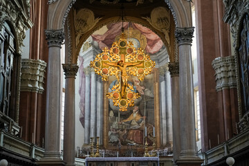 Interior of a cathedral with stained glass windows and statues in Bologna Italy.