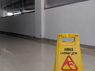 Bright yellow safety sign displaying 