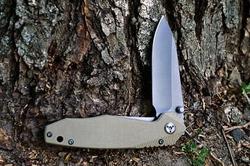 Folding tourist, camping knife with black blade and a handle mad