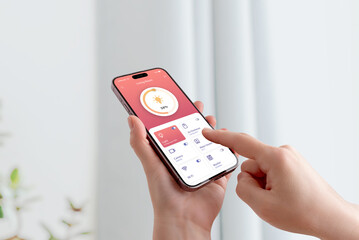 User adjusting room lighting through smartphone interface with modern smart home technology