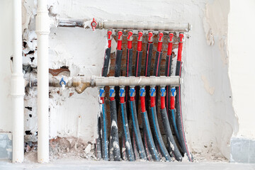 Close up of hot and cold water pipes of a combi boiler.